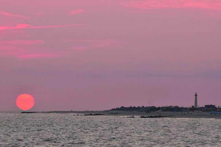 a man holding a frisbee in a body of water