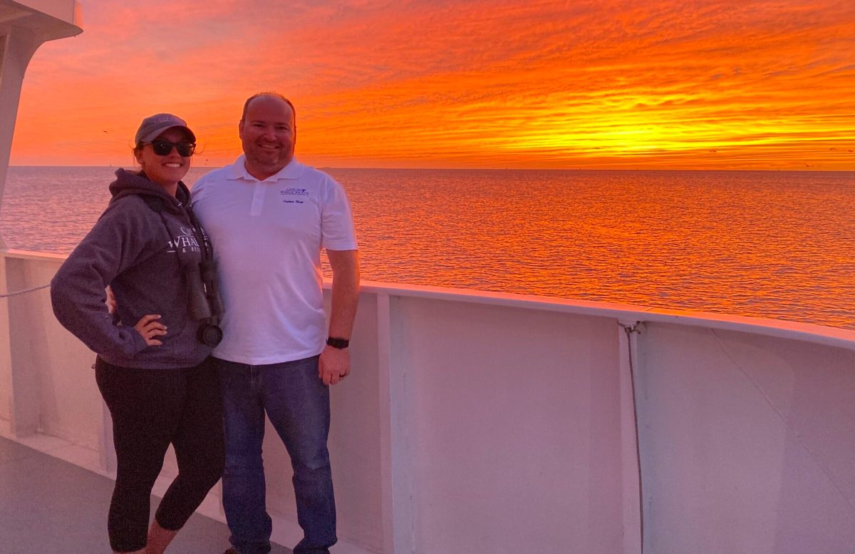 a man standing in front of water