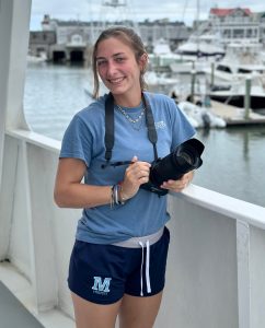 a person standing next to a body of water